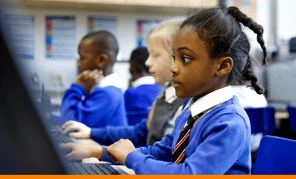 Primary school aged girl sat at computer